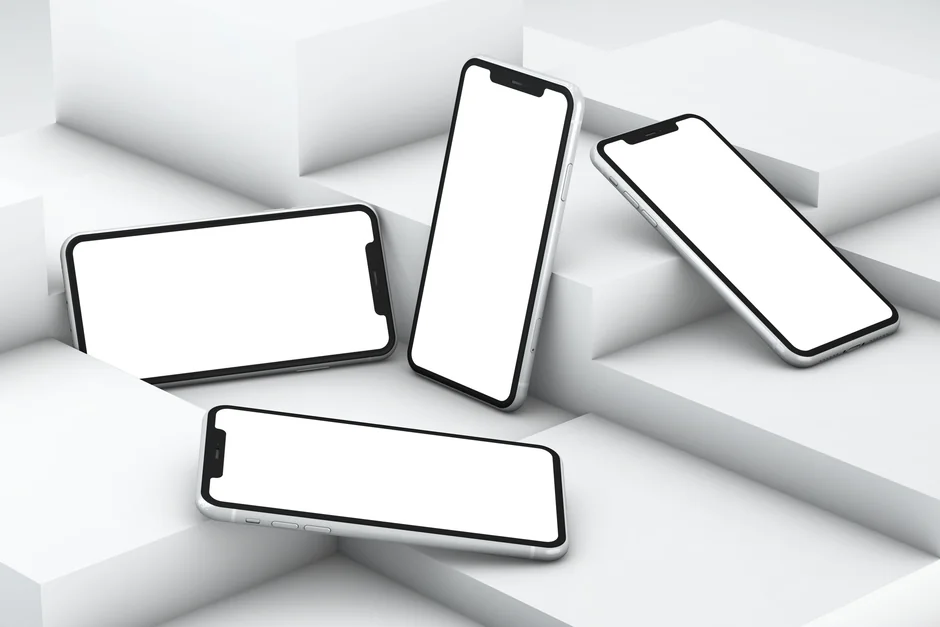 A website wireframe on a macbook screen on an office desk.
